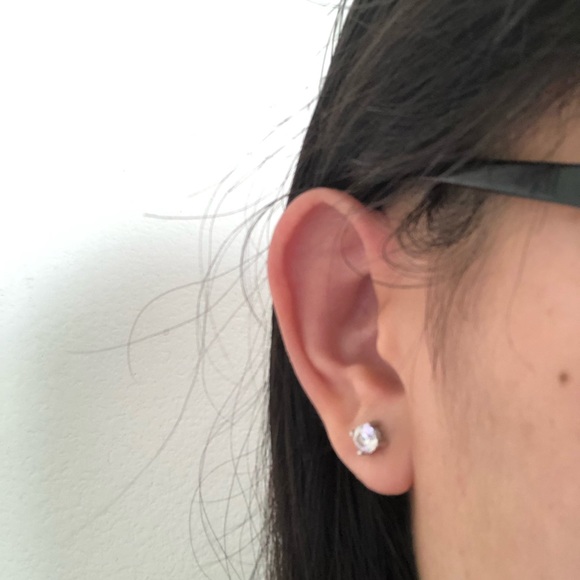 1/8 CT. T.W. Diamond Love Knot Stud Earrings in 20K White Gold - Picture 5 of 5